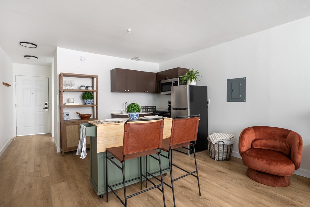 A kitchen with a table and chairs in the middle of the room.