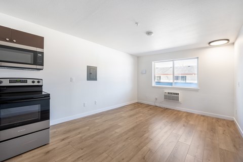 A kitchen with a stove top oven and microwave.