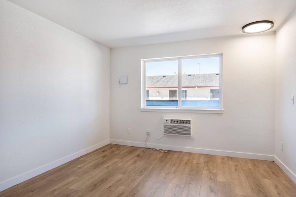 A room with a window and a radiator on the wall.
