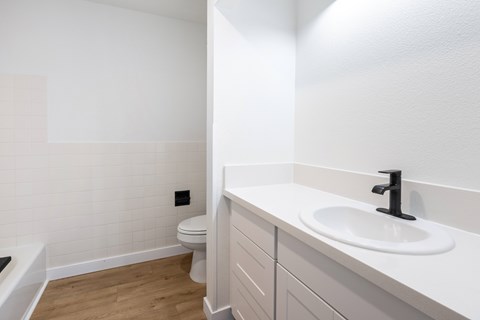 A white bathroom with a toilet and sink.
