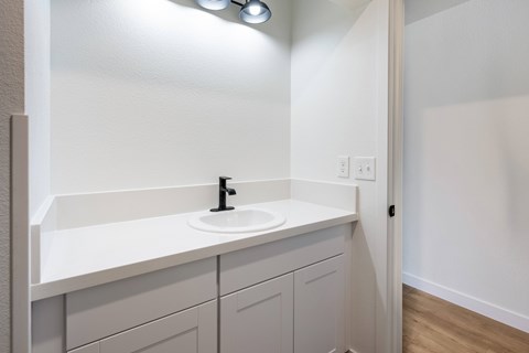 A bathroom with a sink and a mirror.