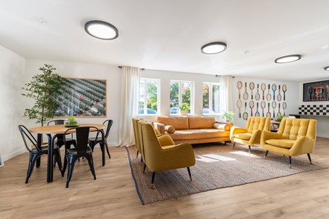 A living room with a yellow sofa and chairs.