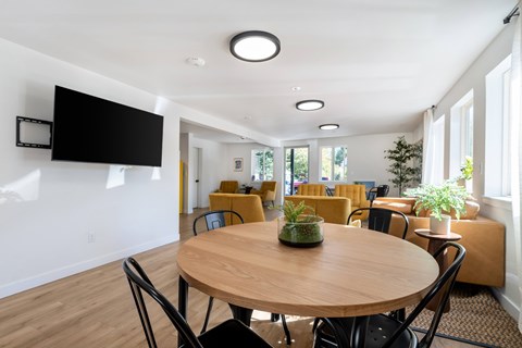 A conference room with a round table and chairs.