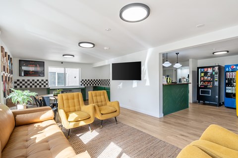 A living room with yellow chairs and a black and white checkered wall.