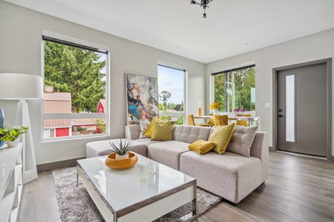 Large living room with oversized windows and bright natural light at Alta Crossing Apartments.