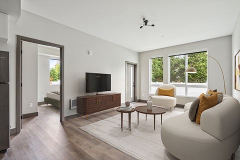 Large living room with oversized windows and bright natural light at Alta Crossing Apartments.