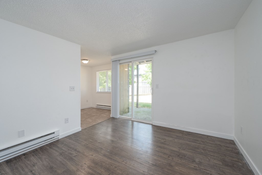 A room with a sliding glass door leading to a backyard.