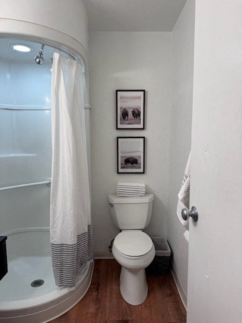 a small bathroom with a toilet and a shower