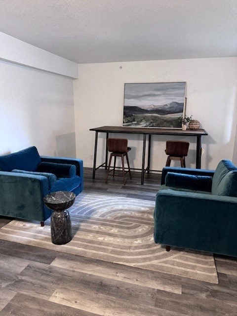a living room with two blue chairs and a table