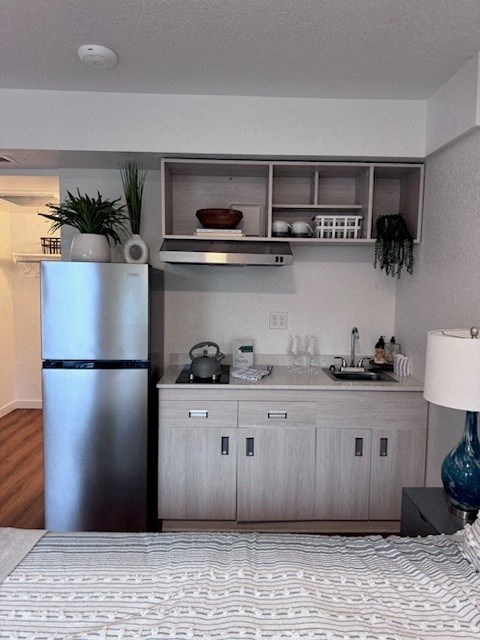 a kitchen with a stainless steel refrigerator and white cabinets