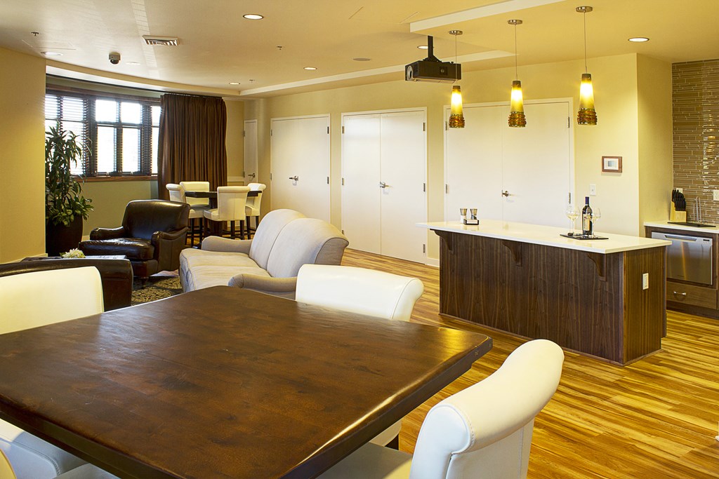 a dining room and living room with a table and chairs