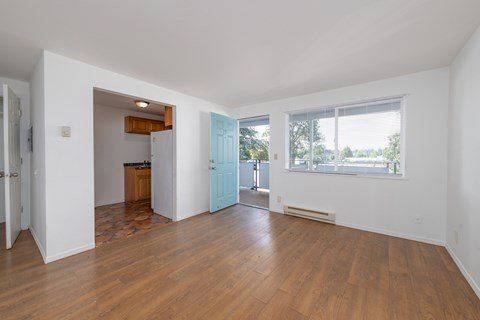 A room with wooden floors and white walls.