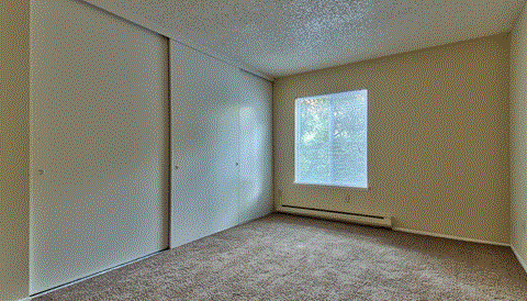 the living room of an empty house with a window