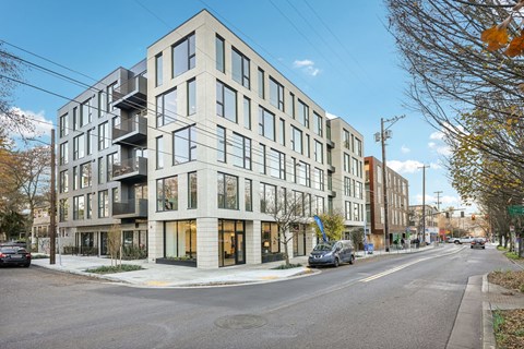 A modern apartment building with a mix of balconies and windows.