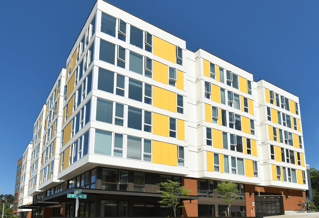 a yellow and white building on a city street