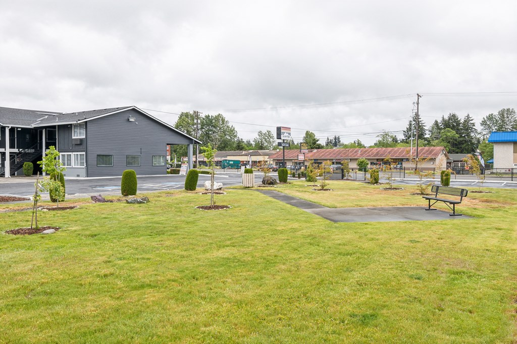 a park with benches in front of a building