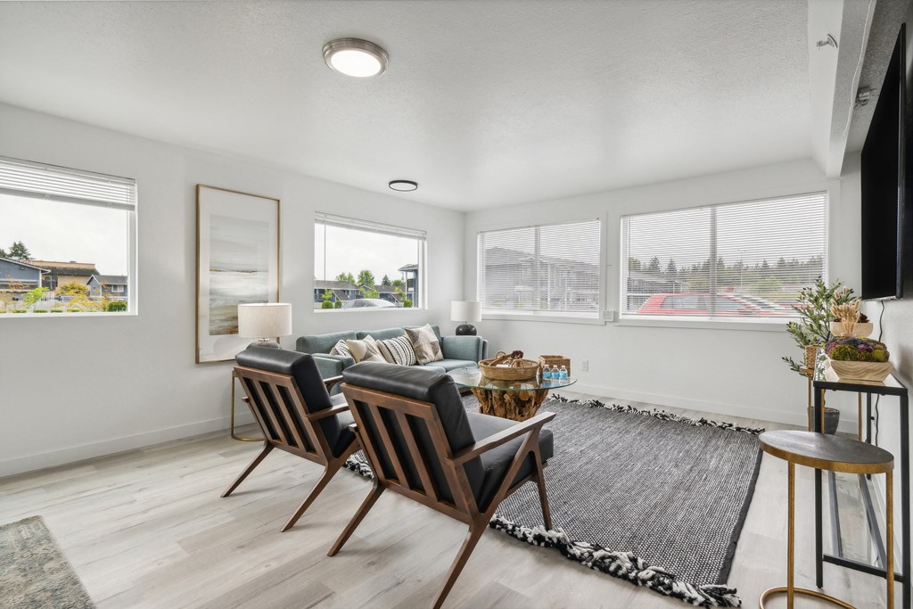 a living room with a couch and a table with chairs
