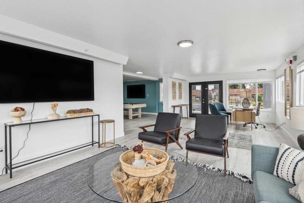 a living room with a couch and chairs and a tv
