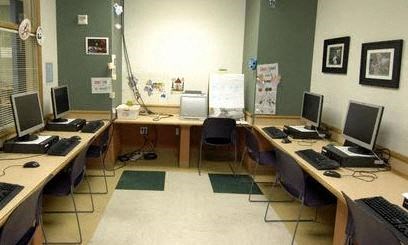 A room with multiple desks and computers.