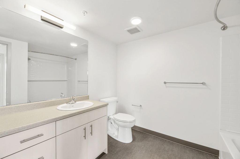 a bathroom with a sink toilet and a mirror