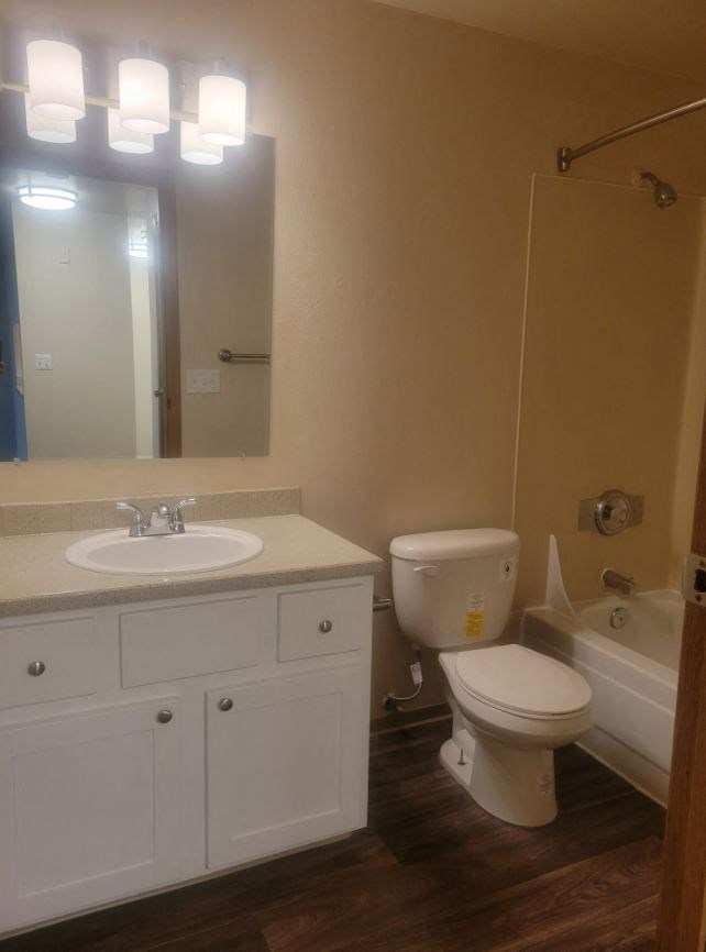 a bathroom with a sink toilet and a mirror