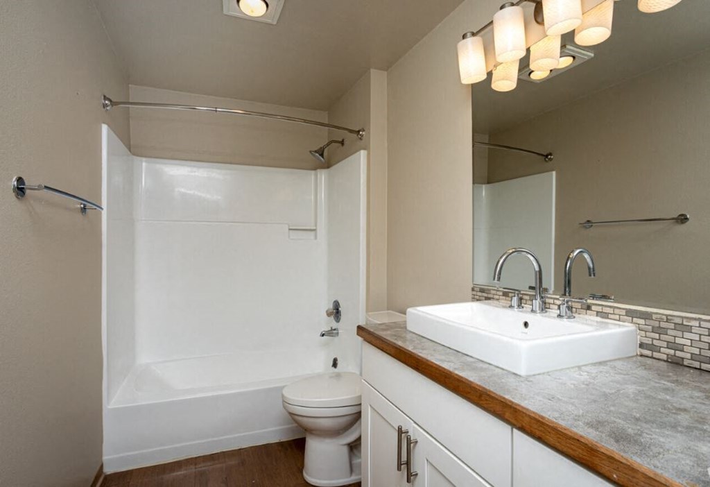 a bathroom with a sink toilet and a bath tub