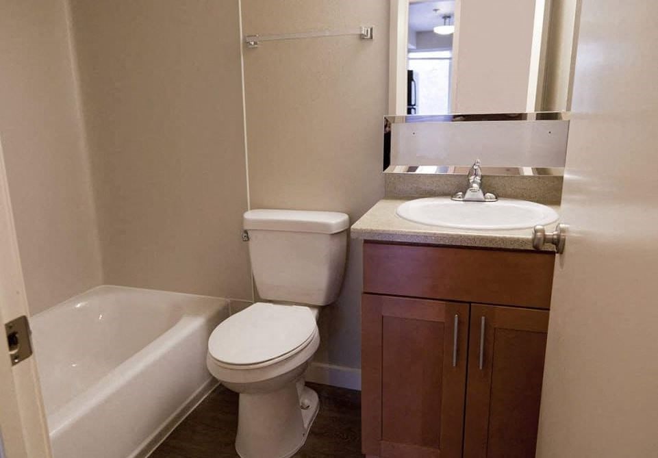 A white toilet sits next to a sink in a small bathroom.