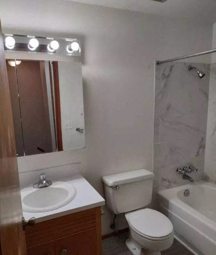 a bathroom with a toilet and a sink and a mirror