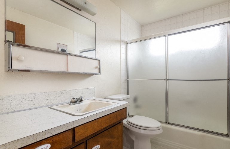a bathroom with a sink toilet and a shower
