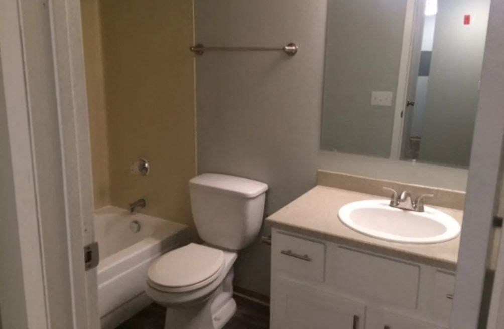 a bathroom with a sink toilet and a bath tub
