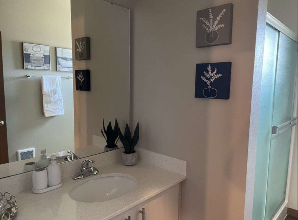 a bathroom with a sink toilet and a mirror