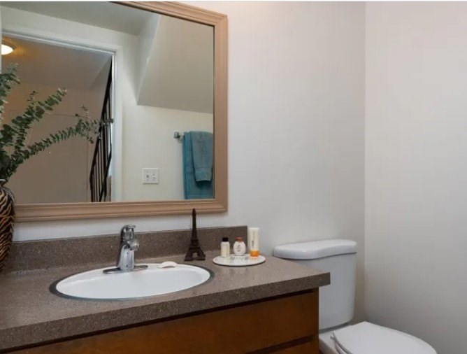 A bathroom with a white sink and a mirror above it.