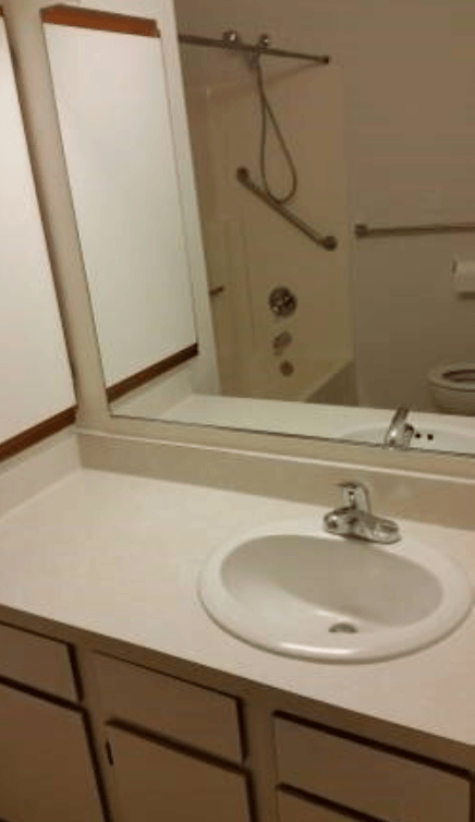 a bathroom with a white sink and a mirror