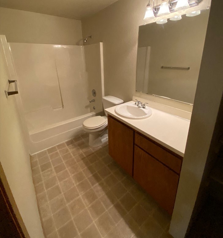 a bathroom with a sink toilet and a shower