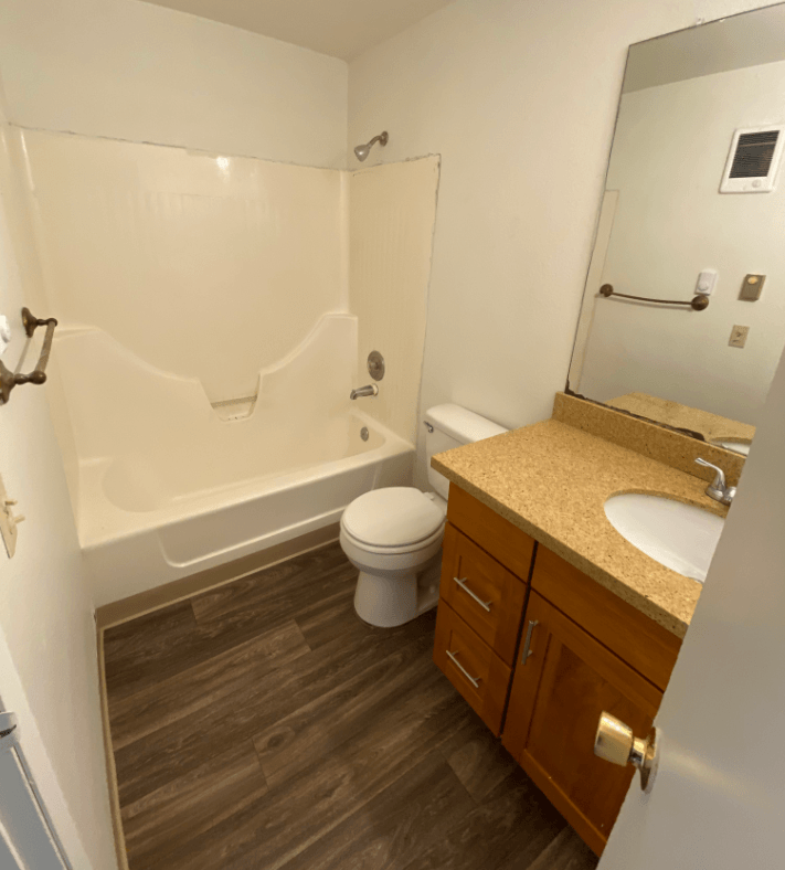 a bathroom with a toilet sink and a tub