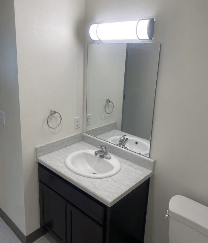 an empty bathroom with a sink and a mirror