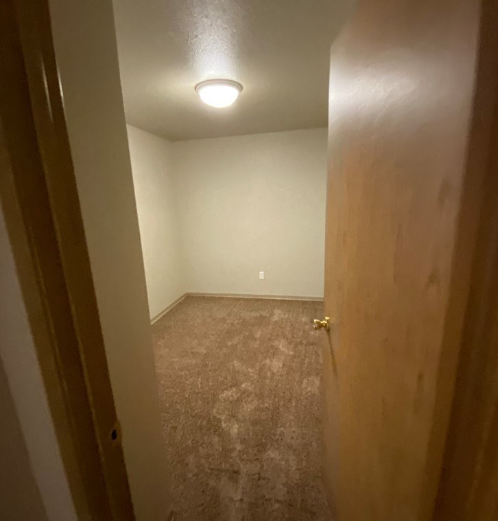 an empty room with a door and a light on the ceiling