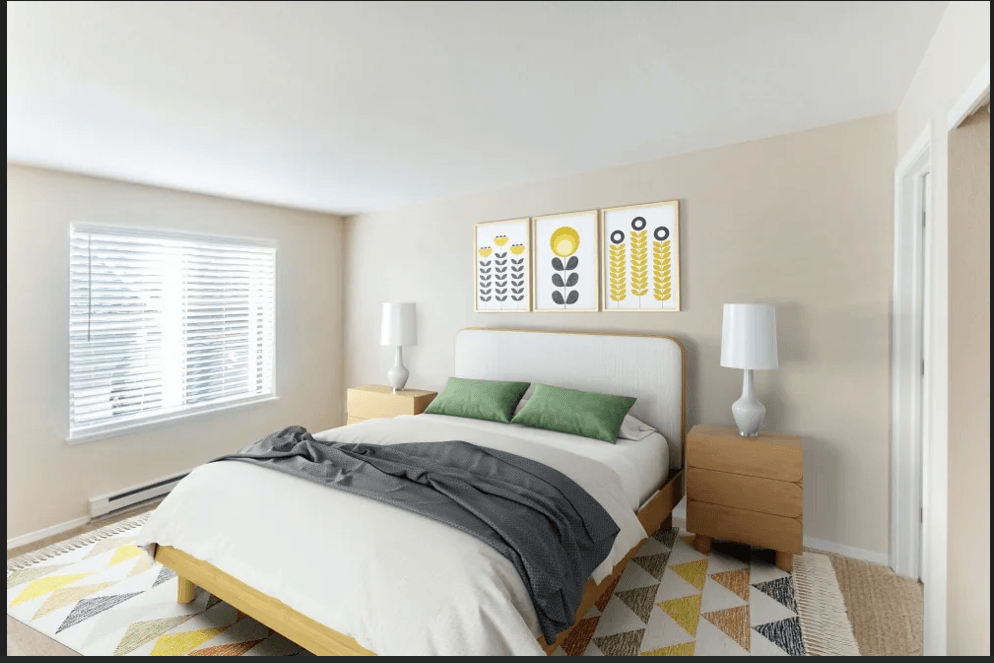 A bedroom with a bed, nightstand, and lamp.