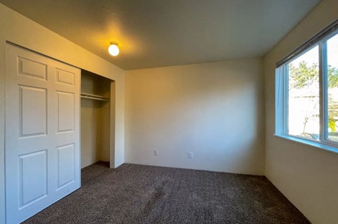 a empty room with a white door and a window