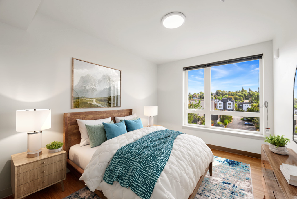 a bedroom with a bed and a large window