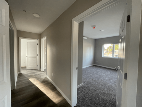 a view of a living room from the hallway of a house