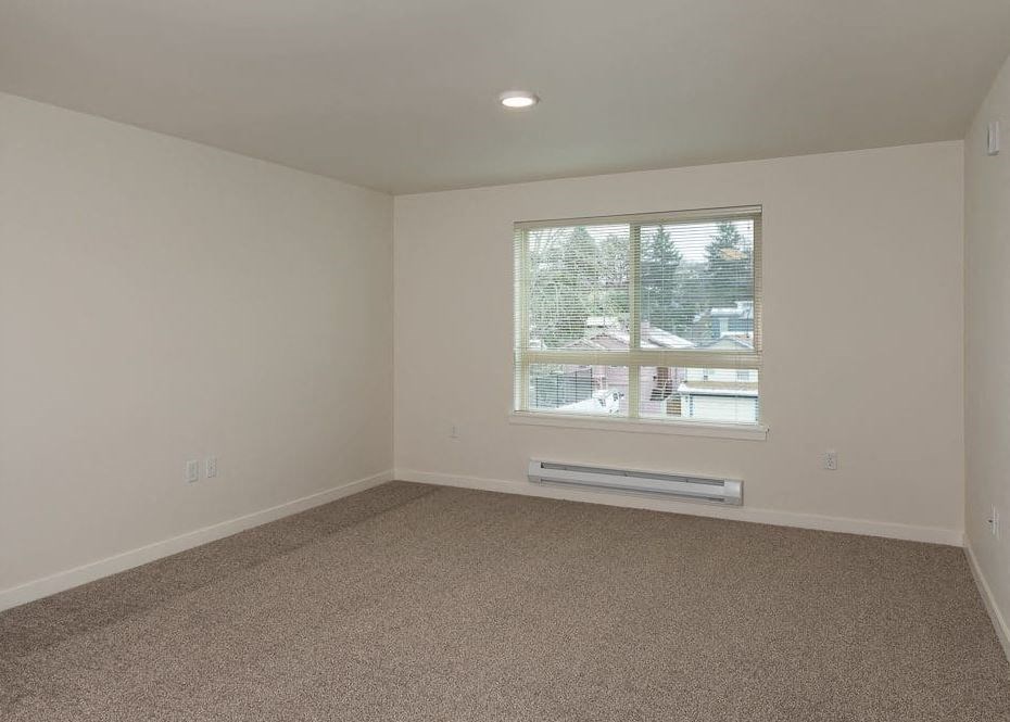 an empty living room with a large window