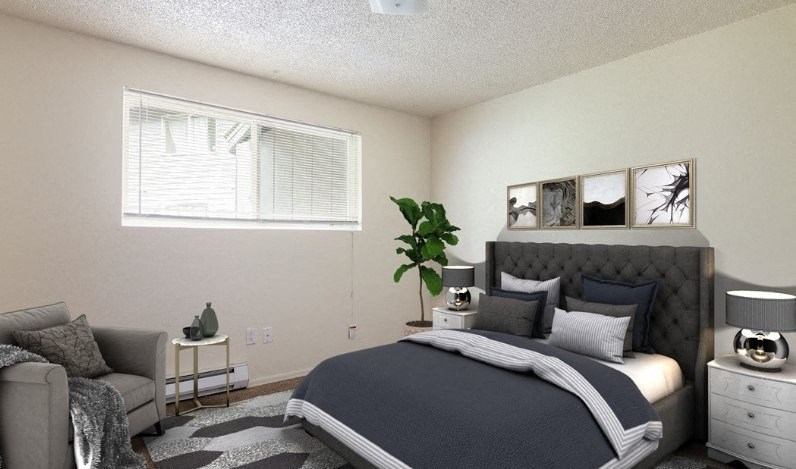 a bedroom with a bed and a couch and a window