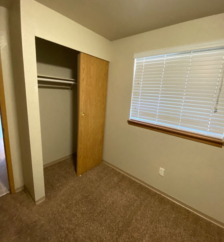 a room with a closet and a window and a door