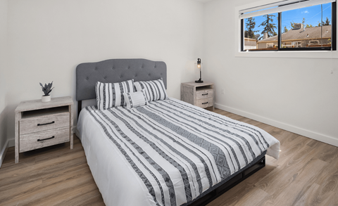 a bedroom with a bed and a window
