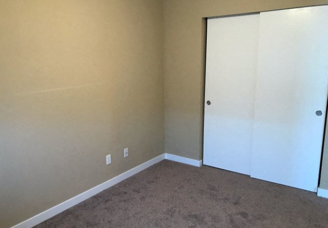 a room with a carpet and a sliding door