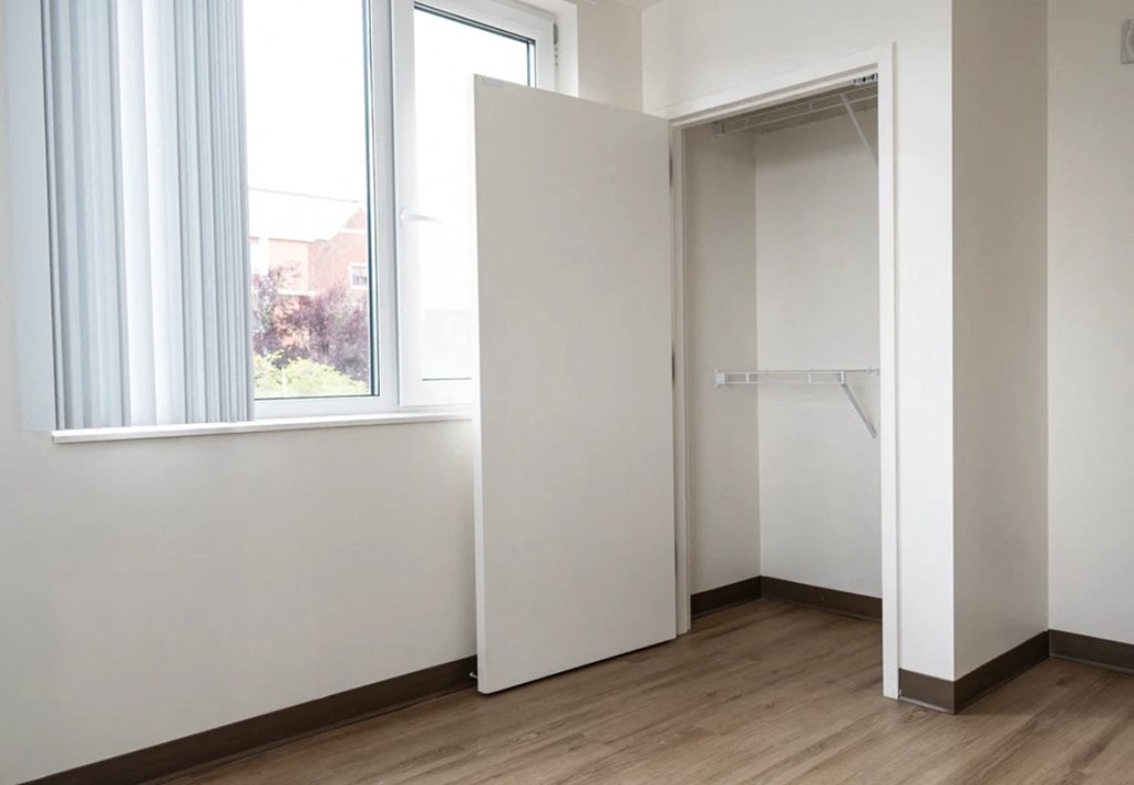 A room with a white door and a window.