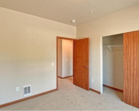 an empty room with a door to a closet