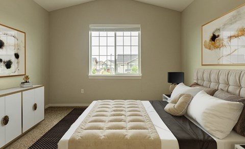 A bedroom with a large bed and a window.