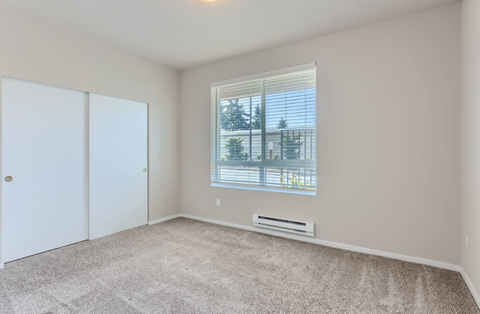 A room with a window and a white door.